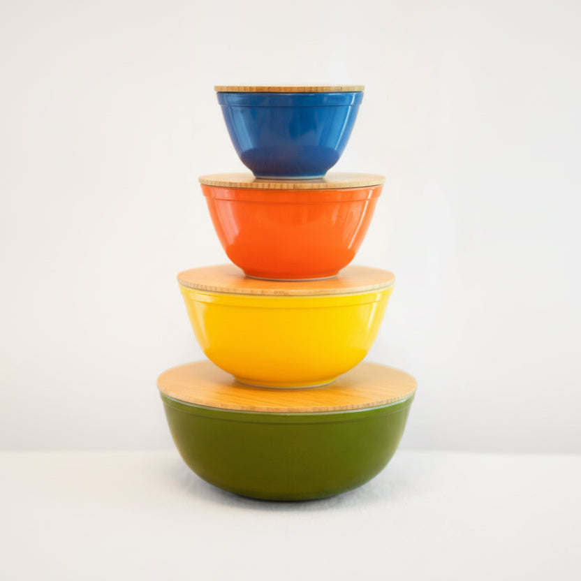 Stack of colorful ceramic bowls on a white background